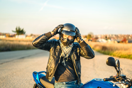 Biker on sport motorcycle outdoor on the roadの写真素材