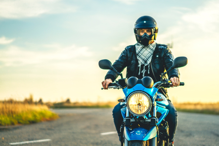 Biker on sport motorcycle outdoor on the roadの写真素材