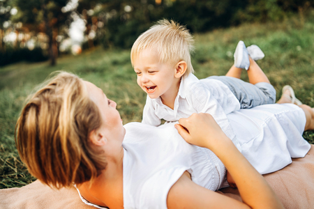 Mother with her little son have fun outdoorの写真素材