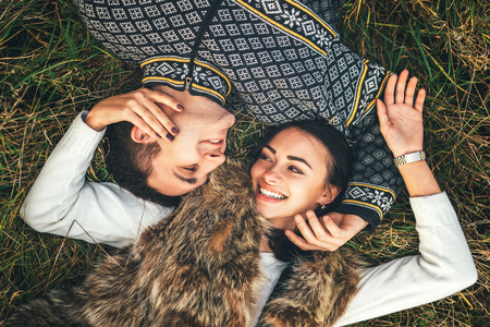 Up view of pretty couple lying in the grassの写真素材