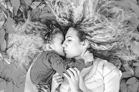 Mother with her little daughter have fun in the parkの写真素材