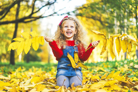 Pretty little girl have fun in the park, autumn timeの写真素材