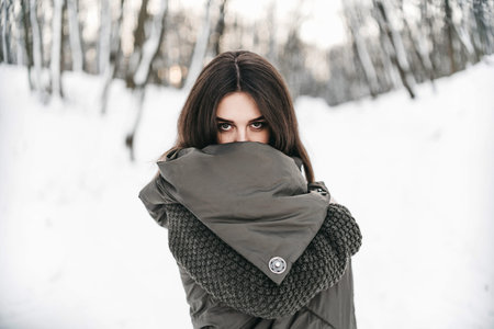 Pretty girl walking in the winter forest