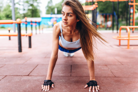 Pretty young sporty girl workout outdoor on the street