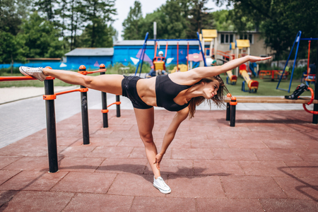 Pretty young sporty girl workout outdoor on the streetの写真素材