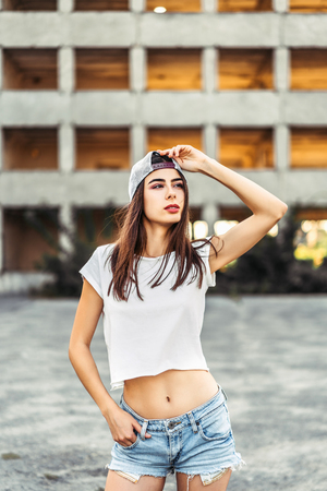 Pretty sporty brunette girl outdoor with old building behindの写真素材