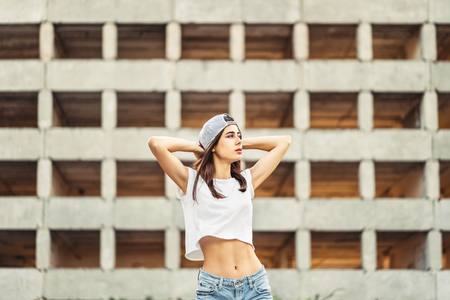 Pretty sporty brunette girl outdoor with old building behindの写真素材