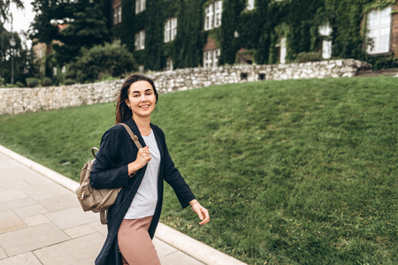 Pretty pan asian tourist girl walking in the tourist place outdoorの写真素材
