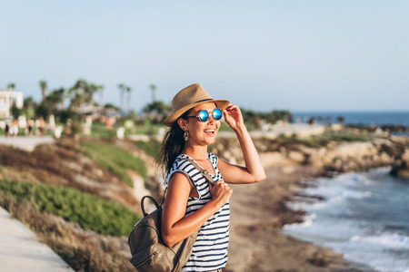 Cute tourist pan asian girl walking outdoor near seaの写真素材