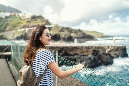 Pretty brunette girl walking outdoor near seaの写真素材