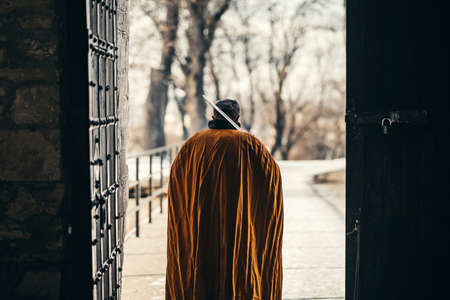 Portrait of a medieval senior warrior man in armor after a battle with dirty and blood-smeared face.の写真素材