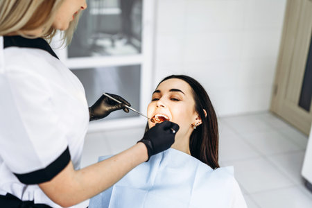 Dentist showing x-ray for the patient and explaining plan of treatment