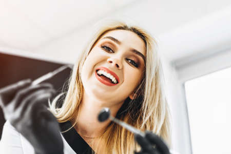 Portrait of the pretty young female dentist in a dental clinicの写真素材