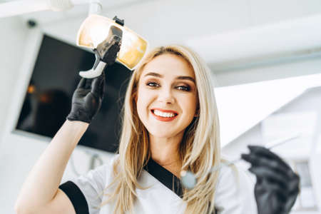 Portrait of the pretty young female dentist in a dental clinicの写真素材