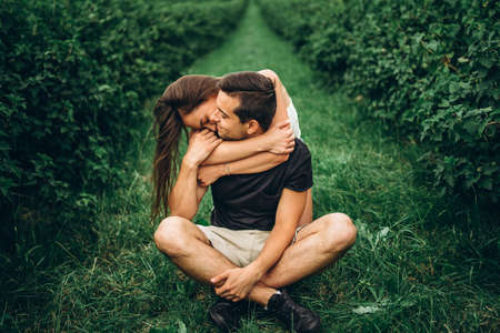 A tender loving couple walking in a field of currant. Man whirls woman in her arms. Love story.の写真素材
