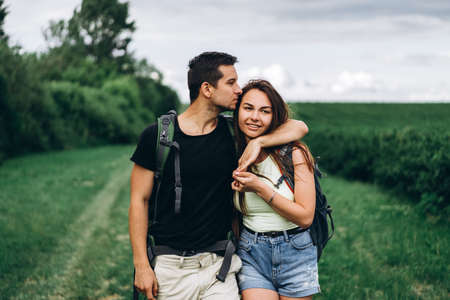 A tender loving couple walking in a field of currant. Man whirls woman in her arms. Love story.の写真素材