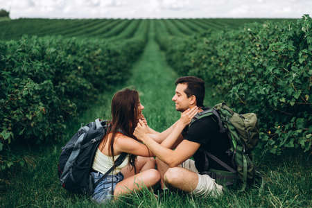 A tender loving couple walking in a field of currant. Man whirls woman in her arms. Love story.の写真素材