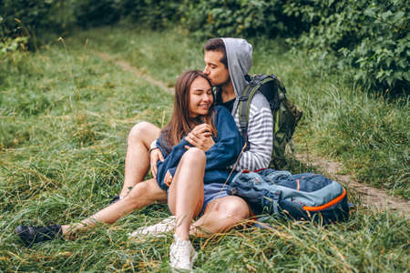 A tender loving couple walking in a field of currant. Man whirls woman in her arms. Love story.の写真素材