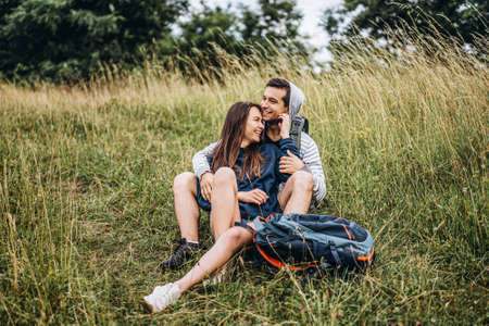 A tender loving couple walking in a field of currant. Man whirls woman in her arms. Love story.の写真素材