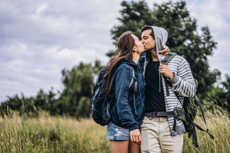 A tender loving couple walking in a field of currant. Man whirls woman in her arms. Love story.の写真素材