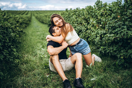 A tender loving couple walking in a field of currant. Man whirls woman in her arms. Love story.の写真素材