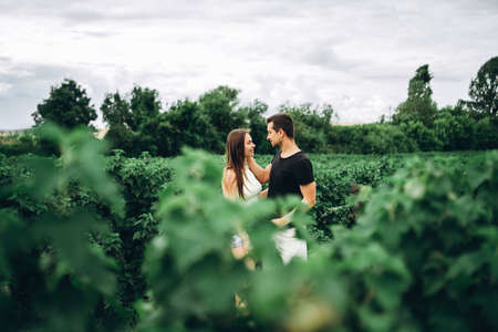 Young couple with backpacks on their backs smiling and walking in the forest, enjoy the walk.の写真素材