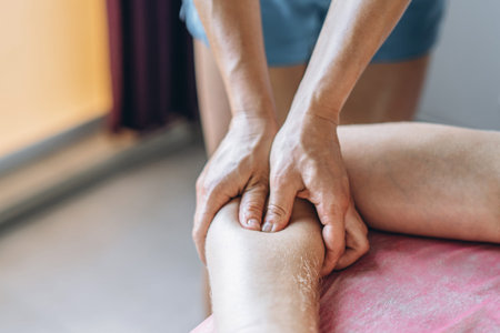 A woman physiotherapist doing back massage for a man in the medical office. Closeup of warm-up of...