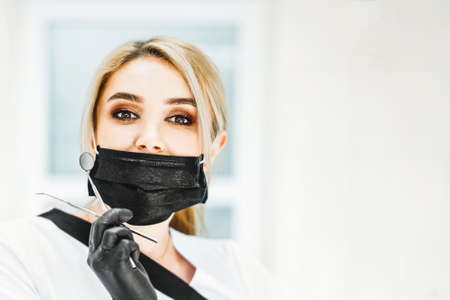 Portrait of the pretty young female dentist in a dental clinicの写真素材
