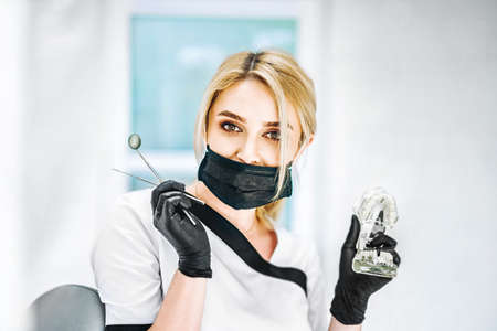 Portrait of the pretty young female dentist in a dental clinicの写真素材