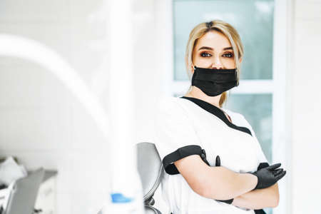 Pertrait photo of the female doctor in black mask and black glovesの写真素材