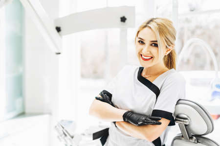 Portrait of the pretty young female dentist in a dental clinicの写真素材