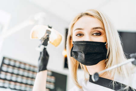 Portrait of the pretty young female dentist in a dental clinicの写真素材
