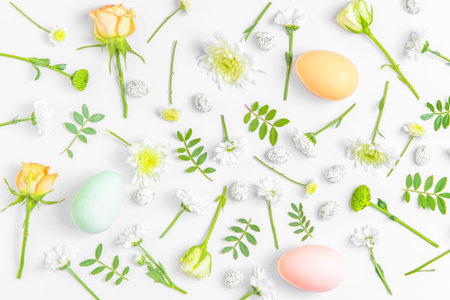 Creative layout composition of flowers and easter eggs on pastel background