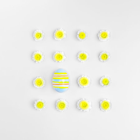 Creative layout composition of flowers and easter eggs on pastel backgroundの写真素材
