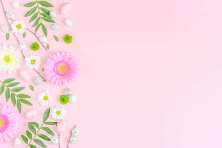 Creative layout composition of flowers and easter eggs on pastel backgroundの写真素材