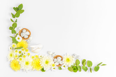Creative layout composition of flowers and easter eggs on pastel backgroundの写真素材