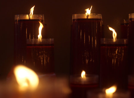 candles lit in a temple that illuminate the prayer room