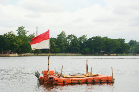 Indonesian flag flying in the middle of the lakeの写真素材