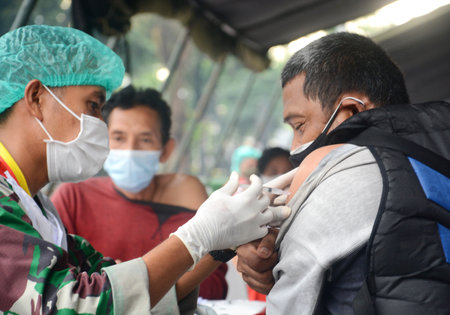 the covid-19 vaccination process for the Indonesian people carried out by the Indonesian military.のeditorial素材