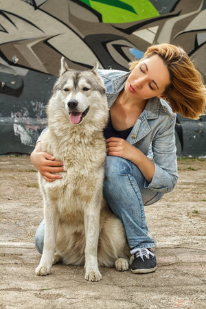 Girl with a dog on the street summer sunny weather