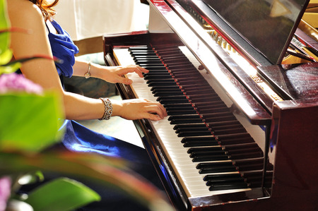 Women playing the grand piano in the roomの写真素材
