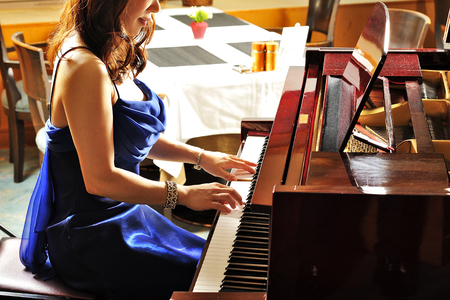 Women playing the grand piano in the roomの写真素材