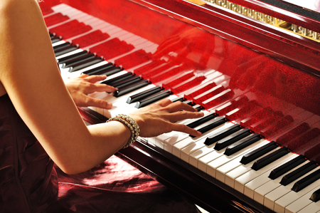 Women playing the grand piano in the roomの写真素材