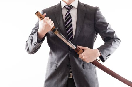 Businessman suit that has a Japanese swordの写真素材