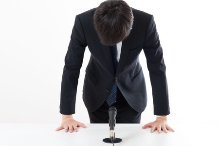 Officers have apologized using a microphone at a press conferenceの写真素材