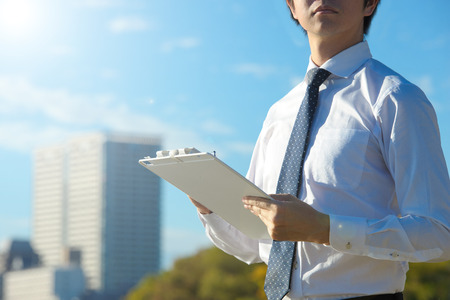 Blue sky and businessman, copy spaceの写真素材