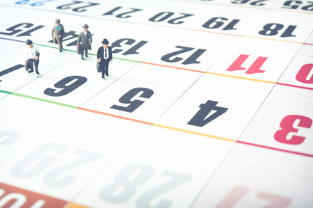Miniature businessman walking on the calendarの写真素材