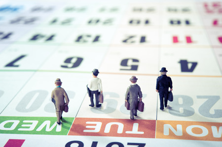 Miniature businessman walking on the calendarの写真素材