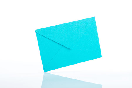 Light blue envelope white backgroundの写真素材
