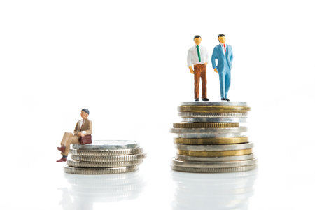 Miniature, man standing on top of the moneyの写真素材
